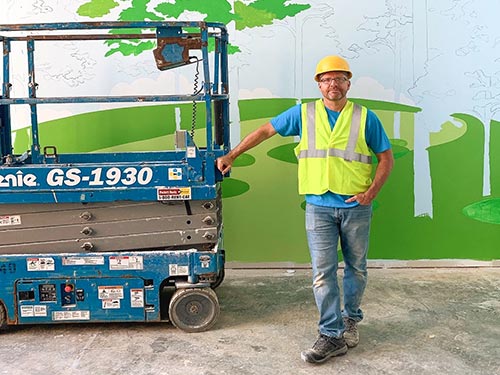 Artist drawing a mural