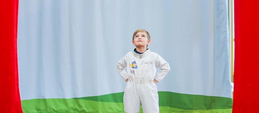 Child on stage in astronaut suit
