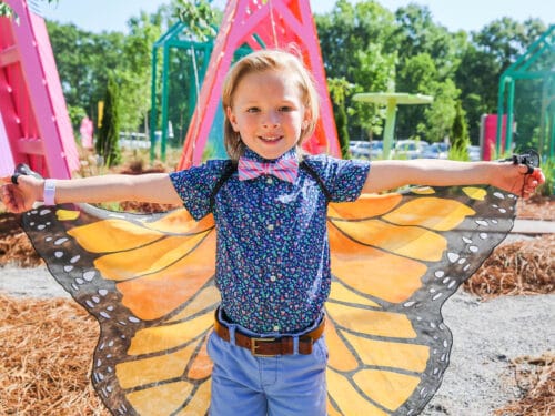 Child wearing butterfly wings