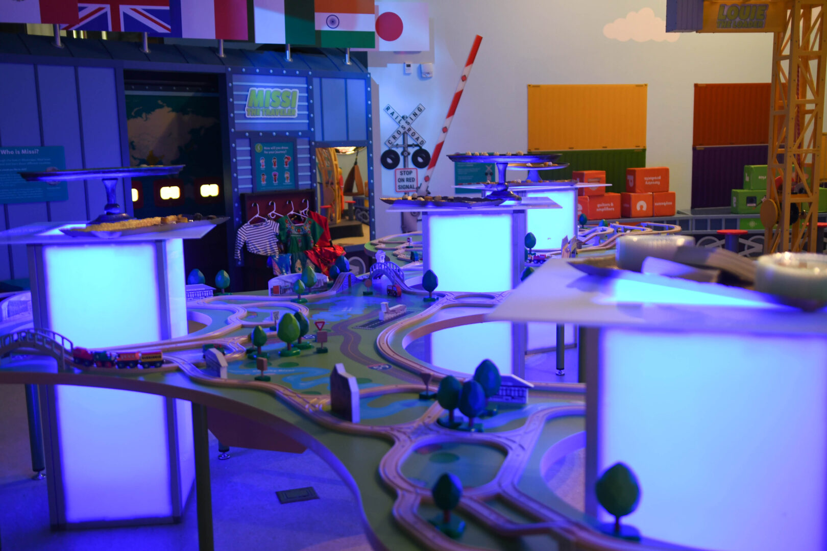 Glowing light boxes inside of a museum train table