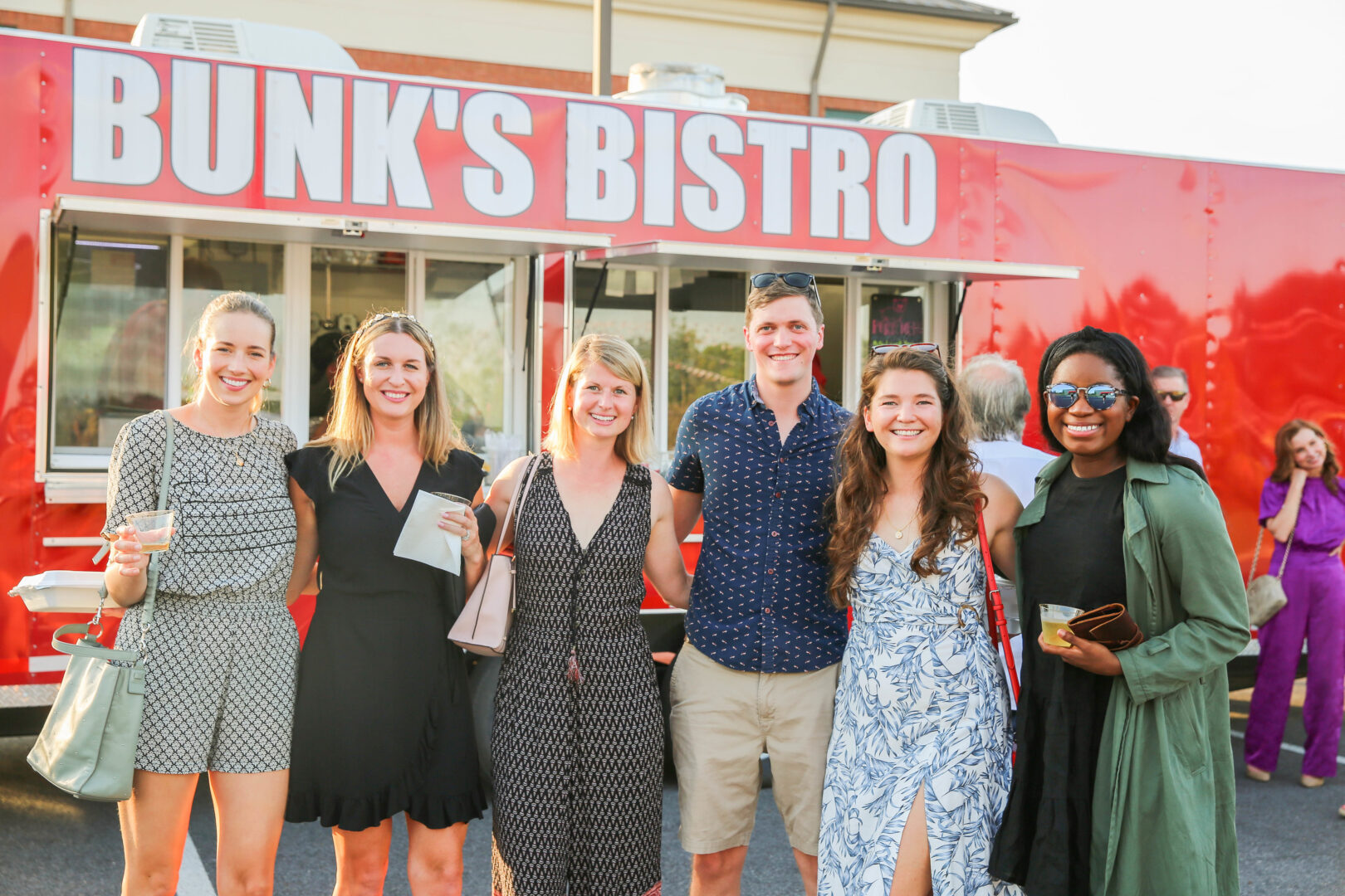 Group of friends standing in front of a food truck